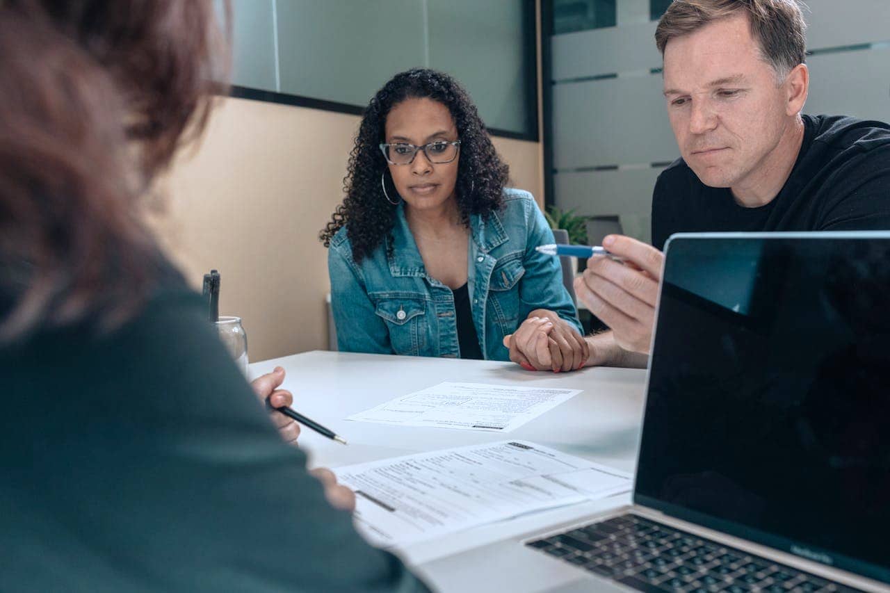 A couple reviewing forms to sign